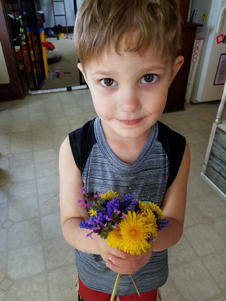 boy holding flowers
