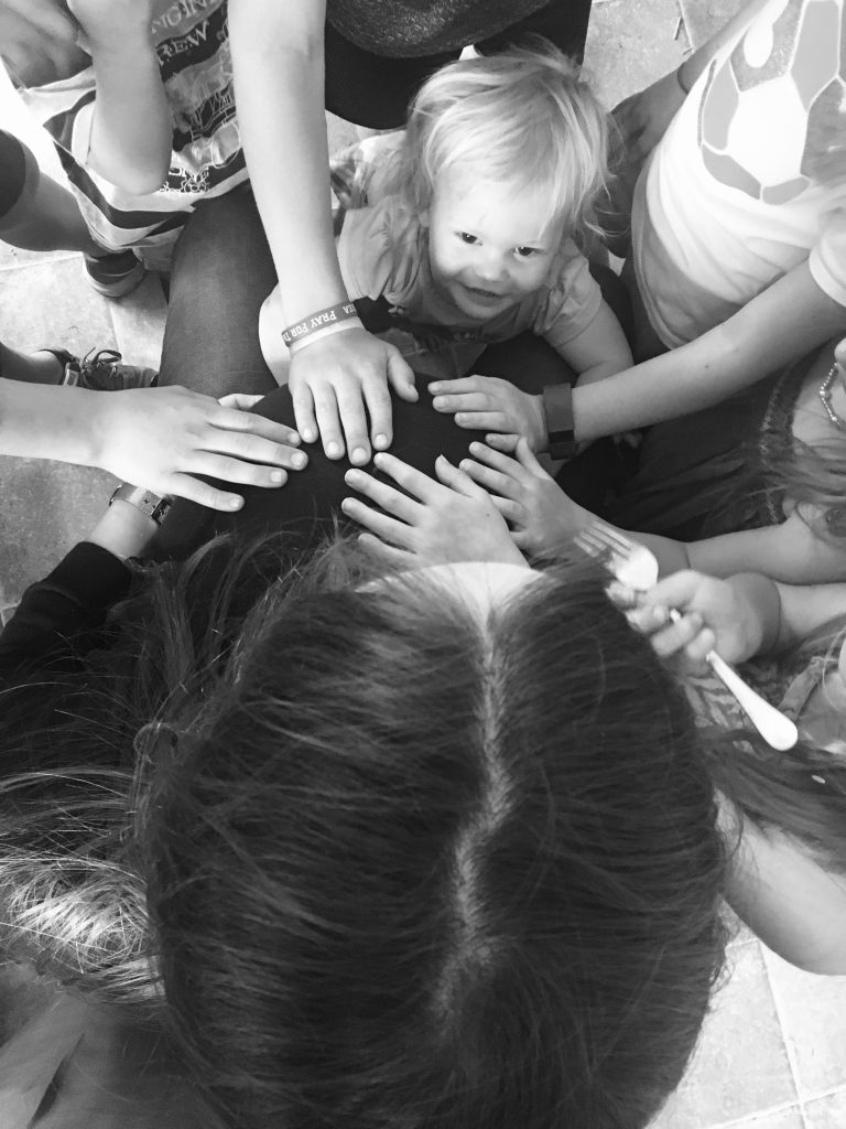 nine months pregnant mom homeschools surrounded by kids