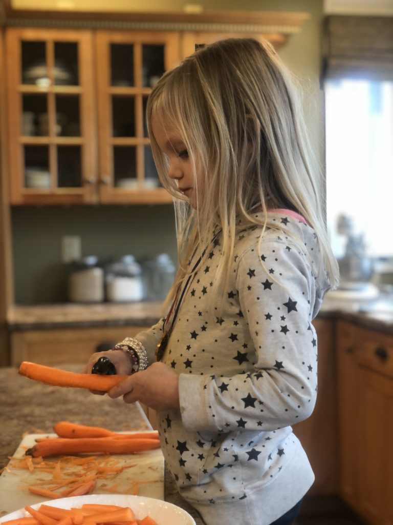 useful life skills: girl peeling a carrot