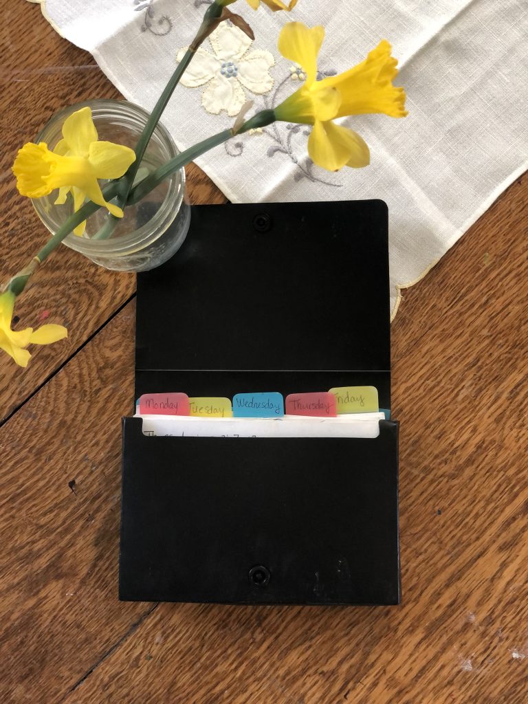 vase of daffodils and catalog of index cards