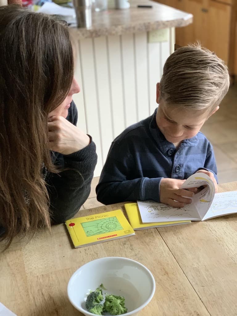 boy reading to mom