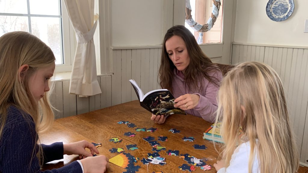 Mom reading Bible to two children