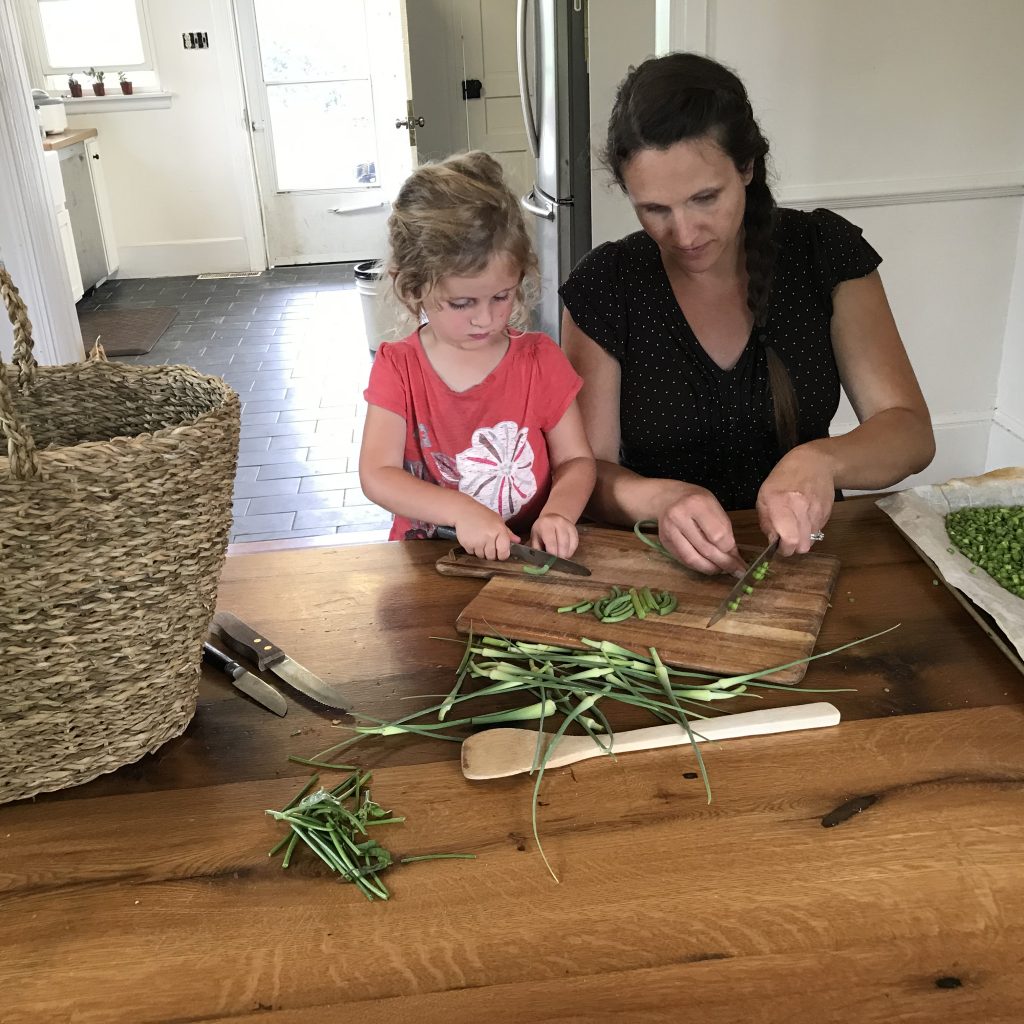 mom and daughter cutting beans