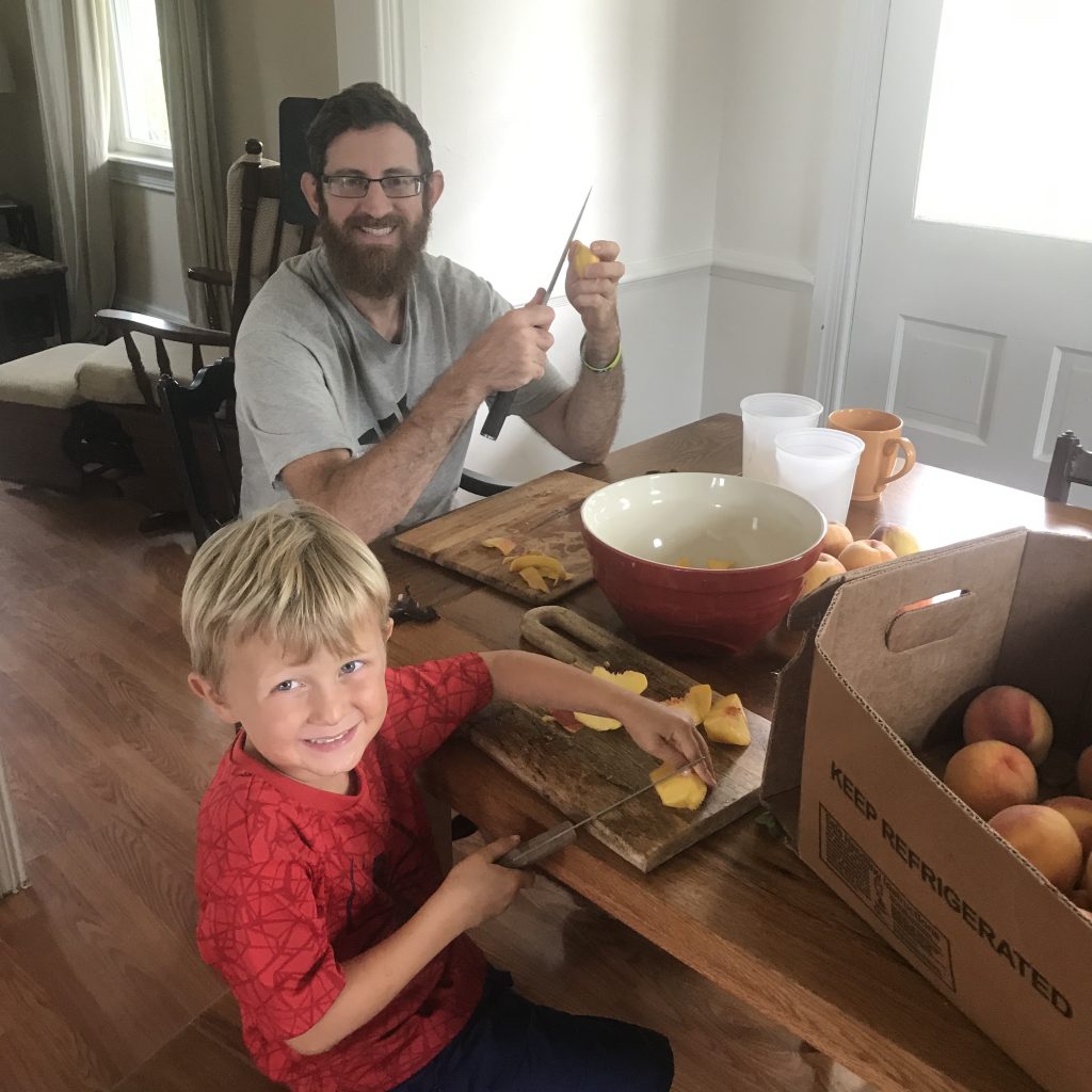 boy and dad cutting apples