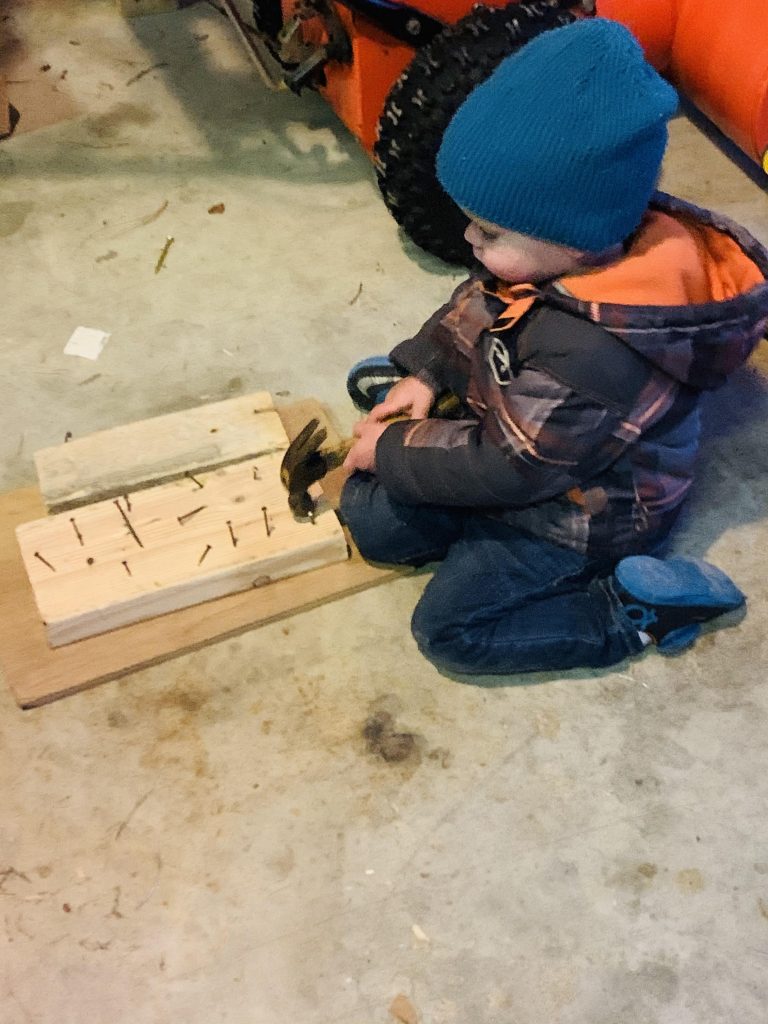 life skills boy hammering nails into a board