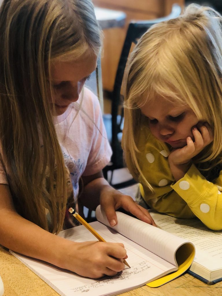 two girls writing